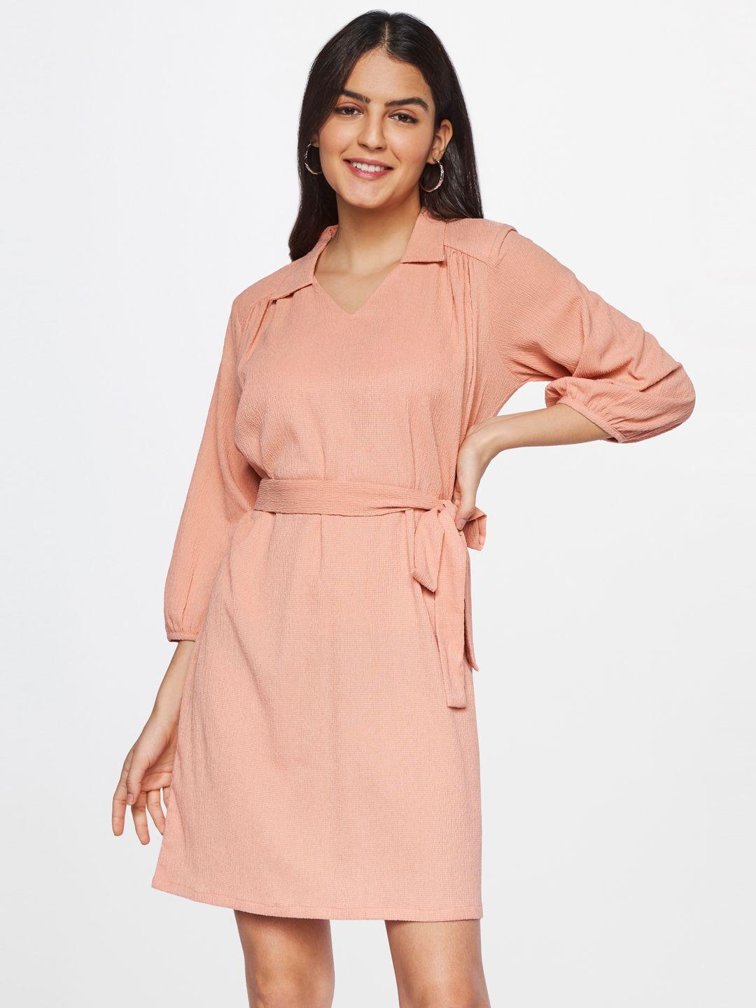 and peach-coloured sheath dress