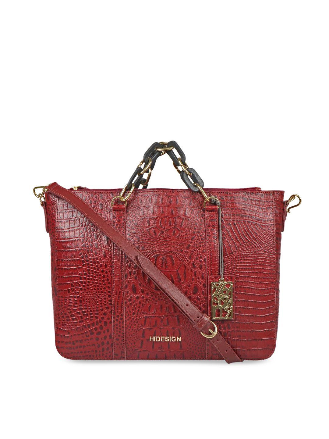 hidesign red textured leather structured handheld bag with cut work