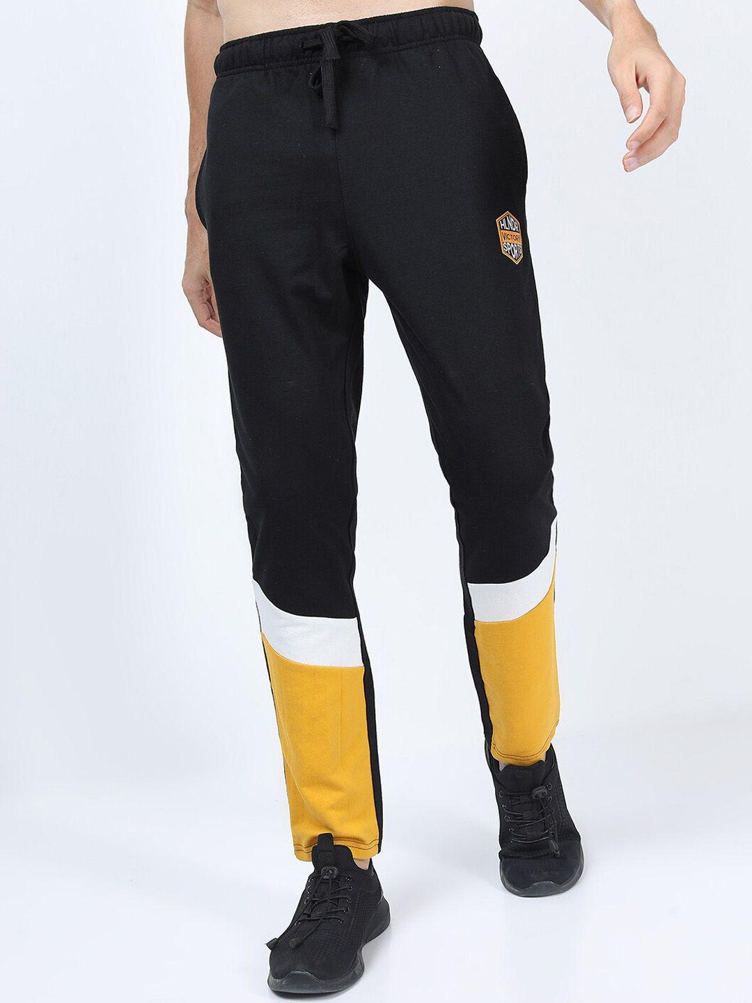 highlander men black & yellow colourblocked slim fit track pants