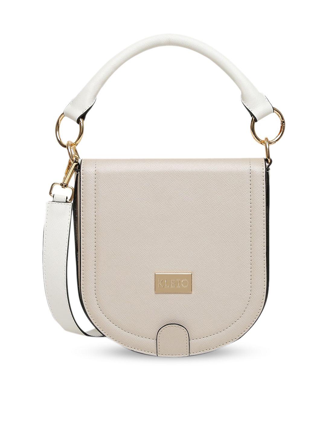 kleio cream-coloured textured pu swagger sling bag with tasselled