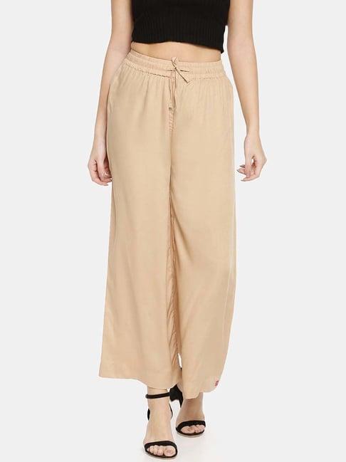 twin birds beige mid rise palazzos