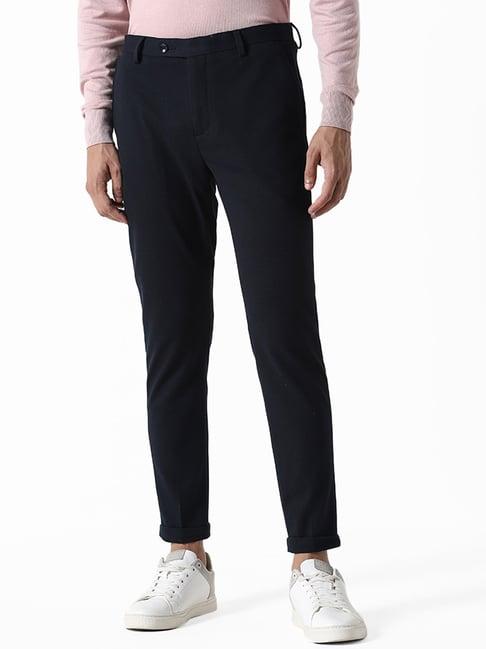 wes formals by westside solid navy blue carrot fit trousers