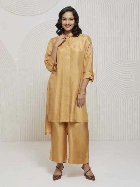 artagai gold earth romancing aari high low hem kurta with embroidered placket and wide leg pants