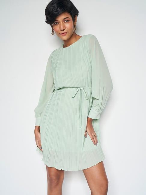 and green pleated a-line dress with belt