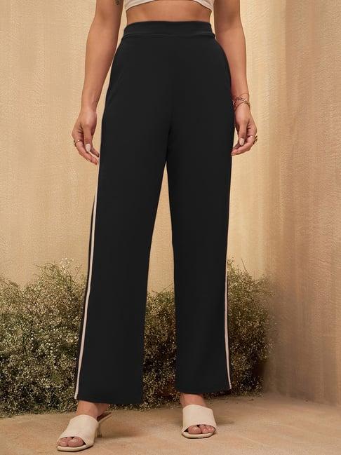 rare women black colour solid regular trousers