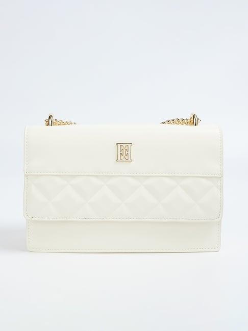 elle off white textured sling handbag