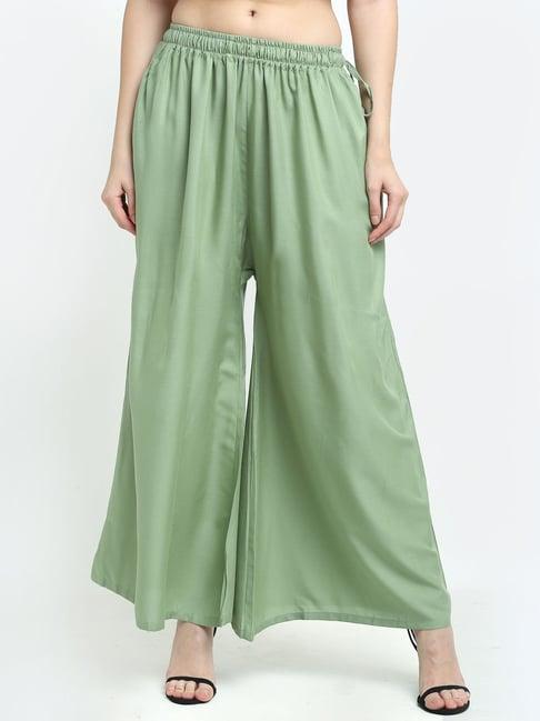 women pista green excess flared rayon palazzo with fully elasticated waistband, slip on closure, drawstrings at the side along with 2 pockets on the side.