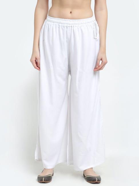 women white excess flared rayon palazzo with fully elasticated waistband, slip on closure, drawstrings at the side along with 2 pockets on the side.