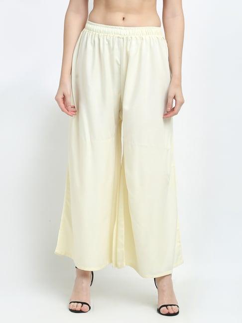 women butter cream excess flared rayon palazzo with fully elasticated waistband, slip on closure, drawstrings at the side along with 2 pockets on the side.